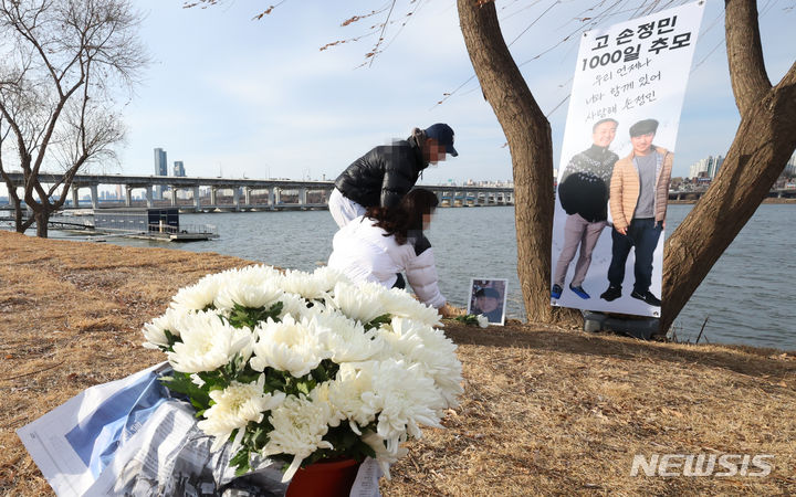 [서울=뉴시스] 최진석 기자 = 서울시가 지난 2021년 4월 한강공원에서 숨진 채 발견된 의대생 고(故) 손정민(당시 22세)씨 추모공간에 대해 자진 철거 명령을 내린 것이 위법이라며 공간 관리자가 제기한 소송이 1심에 이어 2심에서도 각하됐다. 사진은 지난해 1월 서울 반포한강공원에 마련된 손씨를 기리는 1000일 추모공간에서 시민들이 헌화를 하고 있는 모습. 2024.01.19. myjs@newsis.com