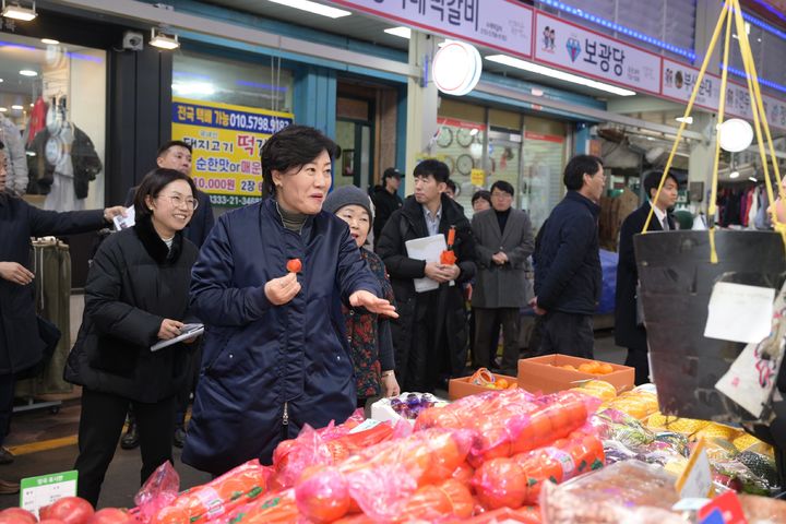 [논산=뉴시스] 송미령 농식품부 장관이 5일 논산 화지시장에서 상인이 건넨 딸기를 먹고 있다. (사진=논산시 제공) 2024.02.06. photo@newsis.com *재판매 및 DB 금지
