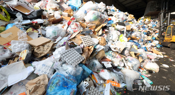 [서울=뉴시스] 조성우 기자 = 설 연휴가 끝난 지난 2024년 2월13일 서울 시내 한 재활용선별장에서 관계자들이 재활용품과 생활폐기물 처리 작업을 하고 있는 모습. 2024.02.13. xconfind@newsis.com