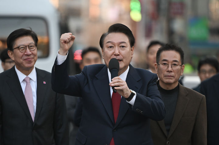 [부산=뉴시스] 윤석열 대통령이 13일 부산시 동래구 동래시장을 방문한 뒤 나서며 시민들에게 주먹을 들어보이며 인사하고 있다. (사진=대통령실 제공) 2024.02.13. photo@newsis.com *재판매 및 DB 금지