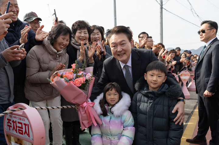 [서울=뉴시스] 윤석열 대통령이 28일 충북 옥천군 고(故) 육영수 여사 생가를 방문해 꽃다발을 전달해준 지역 어린이들과 기념촬영 하고 있다. (사진=대통령실 제공) 2024.02.28. photo@newsis.com *재판매 및 DB 금지