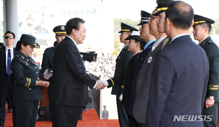 [괴산=뉴시스] 조수정 기자 = 윤석열 대통령이 28일 충북 괴산군 육군학생군사학교에서 열린 2024년 학군장교 임관식에서 해군 최하나 소위에게 계급장을 수여한 뒤 악수하고 있다. 2024.02.28. chocrystal@newsis.com