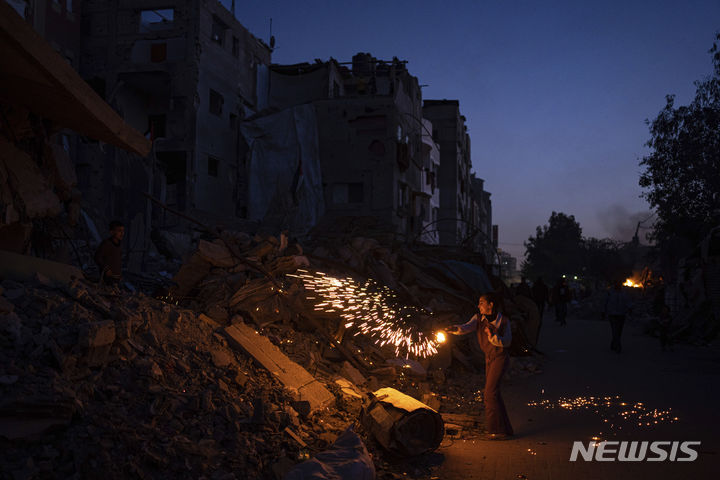 [라파=AP/뉴시스] 10일(현지시간) 가자지구 라파에서 한 팔레스타인 소년이 라마단 시작을 축하하며 불꽃놀이를 하고 있다. 2024.03.13.
