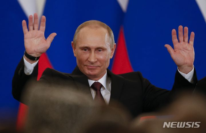 FILE - Russian President Vladimir Putin gestures after signing a treaty incorporating Crimea as part of Russia in the Kremlin in Moscow, Russia, on Tuesday, March 18, 2014. Putin’s quick and bloodless seizure of Ukraine's Crimean Peninsula, home to Russia's Black Sea fleet and a popular vacation site, touched off a wave of patriotism and sent his popularity soaring. "Crimea is ours!" became a popular slogan in Russia. (AP Photo/Alexander Zemlianichenko, File)