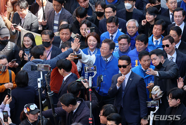 [광주=뉴시스] 이영환 기자 = 이재명 더불어민주당 대표가 21일 오후 광주 북구 전남대학교 후문 상점가를 방문해 시민들과 인사를 나누고 있다. 2024.03.21. 20hwan@newsis.com