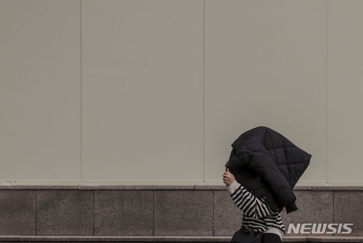 [서울=뉴시스] 정병혁 기자 = 전국 대부분의 지역에 황사와 미세먼지의 영향으로 대기질이 나쁜 가운데 29일 서울 중구 시청역 인근에서 옷으로 머리를 가린 시민이 비를 피해 이동하고 있다. 2024.03.29. jhope@newsis.com