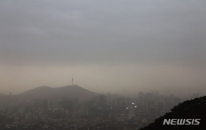 [서울=뉴시스] 김금보 기자 = 전국에 황사가 덮친 29일 오전 서울 종로구 북악산에서 바라본 누런 서울 도심 위로 비구름이 드리우고 있다. 2024.03.29. kgb@newsis.com