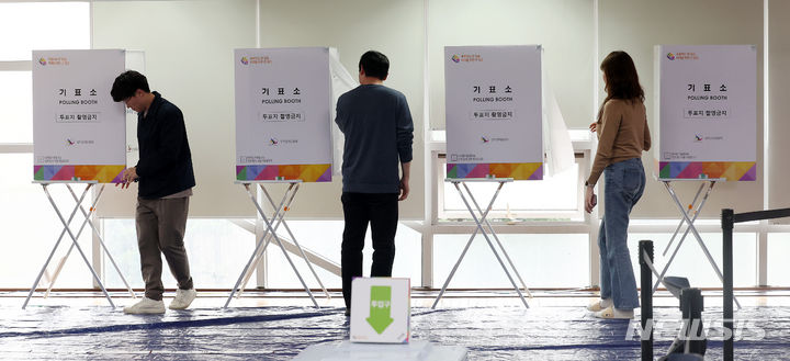 [서울=뉴시스] 김명년 기자 = 4일 오후 서울 용산구 이촌1동사전투표소에서 투표사무원들이 기표소를 점검하고 있다. 2024.04.04. kmn@newsis.com