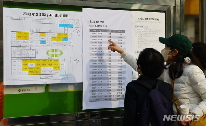 [서울=뉴시스] 김근수 기자 = 올해 첫 검정고시가 실시된 6일 오전 서울 용산구 용강중학교에서 수험생들이 고사장 안내문을 확인하고 있다. 2024.04.06. ks@newsis.com