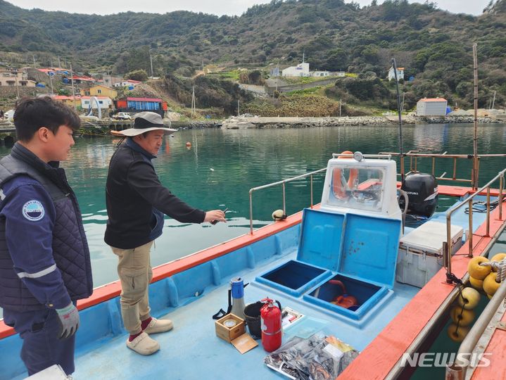 [서울=뉴시스] 한국해양교통안전공단(KOMSA) 검사원이 전남 완도군 여서도 명예 검사원에게 어선 원격검사 방법을 안내하고 있다. 