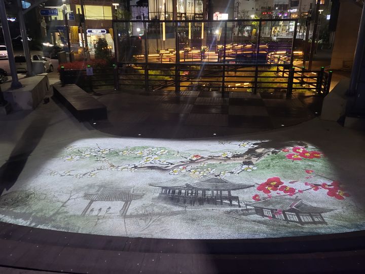 [밀양=뉴시스] 밀양 해천공연장에서 공연예술가를 위한 스마트거리공연장으로 탈바꿈한 공연장 앞 반응형 미디어아트 영상(영남루 사계). (사진=밀양시 제공) 2024.04.16. photo@newsis.com *재판매 및 DB 금지