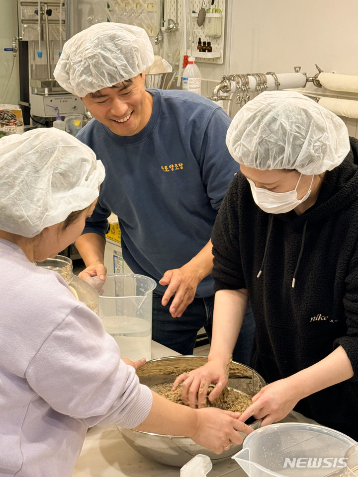[용인=뉴시스] 주민들과 아토양조장 관계자가 막걸리를 만들고 있다. (사진제공=용인시)