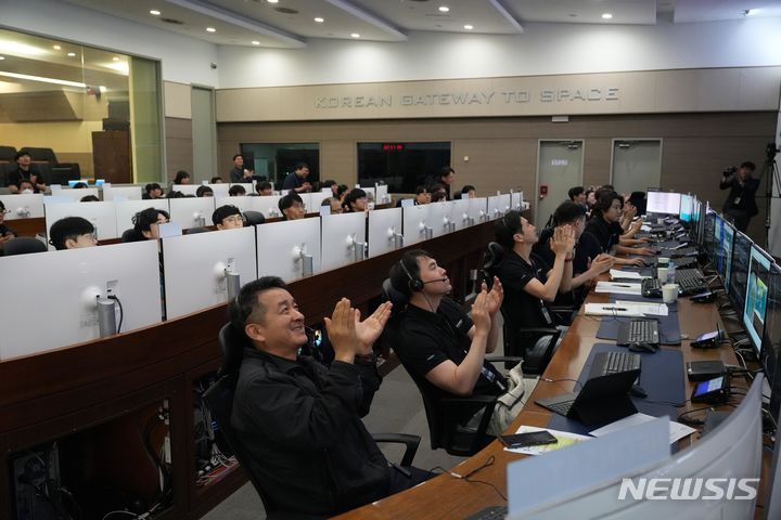 [서울=뉴시스]한국 최초로 양산을 위해 개발된 '초소형군집위성 1호'가 국내 지상국과 교신에 성공한 이후 관제팀이 환호하고 있다. (사진=과기정통부 제공)