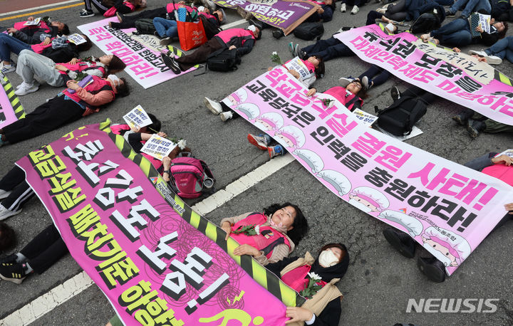 [서울=뉴시스] 김금보 기자 = 전국민주노동조합총연맹 조합원들이 24일 오후 서울 종로구 보신각 앞에서 열린 작업중지권과 산업안전보건법 전면 적용 쟁취를 위한 행진 결의대회에서 노동재해를 추모하는 다이인(die in) 퍼포먼스를 하고 있다. 2024.04.24. kgb@newsis.com