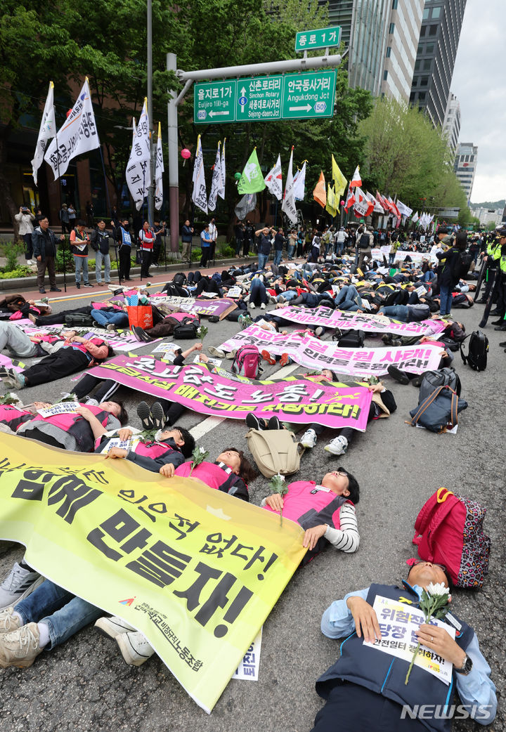 [서울=뉴시스] 김금보 기자 = 전국민주노동조합총연맹 조합원들이 24일 오후 서울 종로구 보신각 앞에서 열린 작업중지권과 산업안전보건법 전면 적용 쟁취를 위한 행진 결의대회에서 노동재해를 추모하는 다이인(die in) 퍼포먼스를 하고 있다. 2024.04.24. kgb@newsis.com