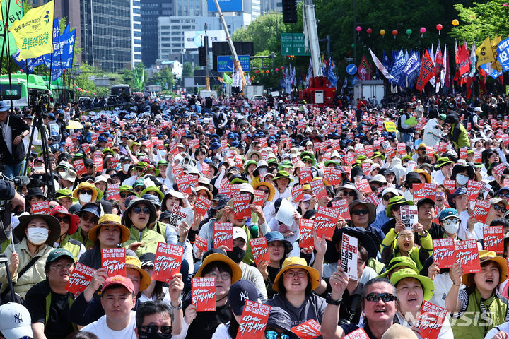 [서울=뉴시스] 김근수 기자 = 세계노동절인 1일 서울 종로구 동화면세점 인근에서 전국민주노동조합총연맹 조합원들이 구호를 외치고 있다. 2024.05.01. ks@newsis.com