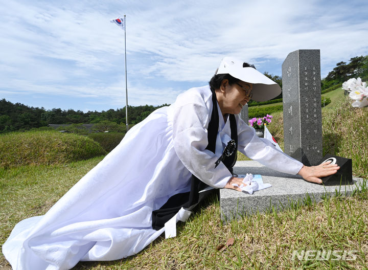 [광주=뉴시스] 박기웅 기자 = 5·18민주화운동 44주기를 하루 앞둔 17일 오전 광주 북구 운정동 국립5·18민주묘지에서 고(故) 임은택 열사의 부인 최정희 여사가 먼저 떠나보낸 남편의 이름을 부르고 있다. 2024.05.17. pboxer@newsis.com