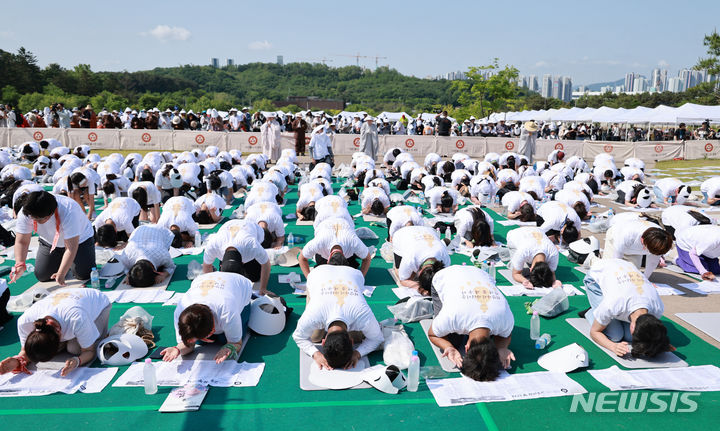 [양주=뉴시스] 전신 기자 = 19일 경기도 양주 회암사지 특설무대에서 열린 '회암사 사리 이운 기념 문화축제 및 삼대화상 다례재'에서 참석자들이 108배를 하고 있다. (대통령실통신사진기자단) 2024.05.19. photo1006@newsis.com