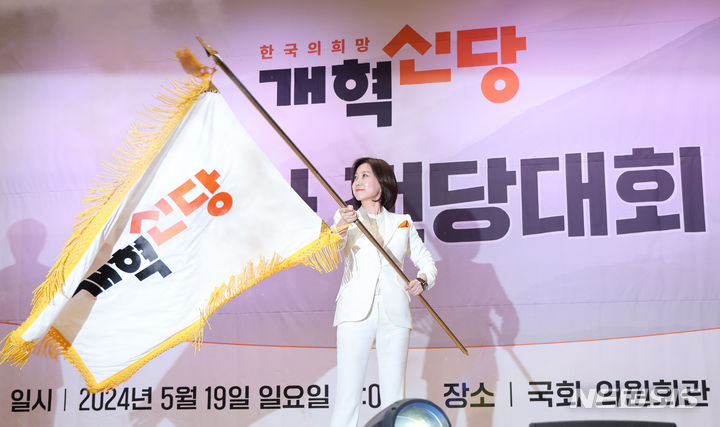[서울=뉴시스] 권창회 기자 = 허은아 개혁신당 당대표 후보가 19일 서울 여의도 국회의원회관에서 열린 전당대회에서 당대표에 당선된뒤 당기를 흔들고 있다. 2024.05.19. kch0523@newsis.com