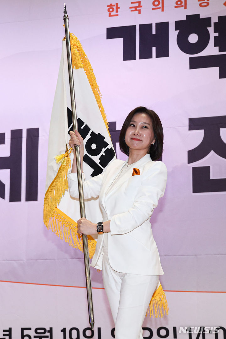 [서울=뉴시스] 권창회 기자 = 허은아 개혁신당 당대표 후보가 19일 서울 여의도 국회의원회관에서 열린 전당대회에서 당대표에 당선된뒤 당기를 흔들고 있다. 2024.05.19. kch0523@newsis.com
