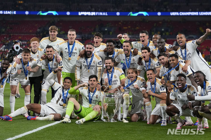 [런던=AP/뉴시스] 스페인 프로축구 프리메라리가 레알 마드리드 선수단이 1일(현지시각) 영국 런던의 웸블리 스타디움에서 보루시아 도르트문트(독일)을 꺾고 '2023~2024시즌 유럽축구연맹(UEFA) 챔피언스리그(UCL)' 결승전에서 우승을 차지한 뒤, 세리머니를 하고 있다. 2024.06.01.