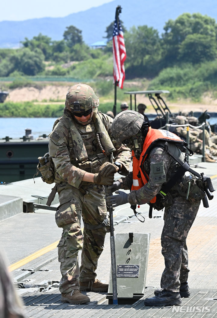 [여주=뉴시스] 김종택기자 = 한미연합 제병협동 도하훈련이 실시된 5일 경기도 여주시 연양동 남한강 일대에서 한미장병들이 부교를 설치하고 있다. 이날 훈련에는 육군 7공병여단과 2항공여단 301항공대대, 2기갑여단 기계화보병대대, 미2사단/한미연합사단 등 590여명이 참가했다. 2024.06.05. jtk@newsis.com