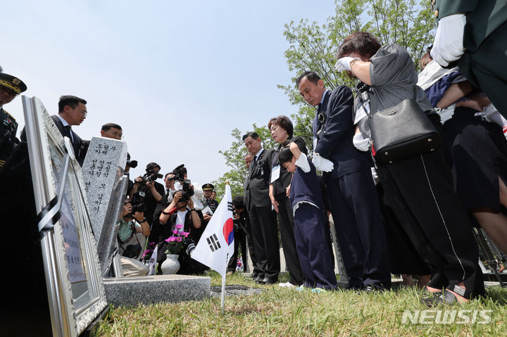 [서울=뉴시스] 황준선 기자 = 5일 오전 서울 동작구 국립서울현충원에서 열린 호국의 형제 안장식에서 신원식 국방부 장관과 유가족들이 故 전병섭 하사와 故 전병화 이등상사의 묘비에 대한 설명을 듣고 있다. 2024.06.05. hwang@newsis.com
