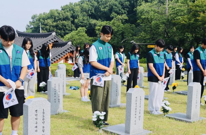 [전주=뉴시스] 지난 6일 봉사활동을 위해 전북 전주군경묘지를 찾은 전북 청소년적십자 단원들이 묘지 앞에서 묵념을 드리고 있다. (사진=대한적십자사 전북특별자치도지사 제공) 2024.06.07. photo@newsis.com *재판매 및 DB 금지