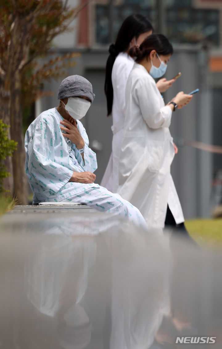 [서울=뉴시스] 김명년 기자 = 서울대학교 의과대학 교수들이 오는 17일부터 응급·중환자실을 제외하고 전체 휴진을 결정한 가운데 7일 오후 서울 종로구 서울대학교병원에서 한 환자가 야외의자에  앉아 있다. 2024.06.07. kmn@newsis.com