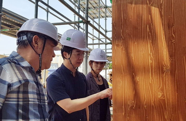 고창 황윤석도서관 건립현장을 방문한 홍익대 유현준 교수(가운데)가 건축물에 사용된 자재의 재질을 살피고 있다. *재판매 및 DB 금지