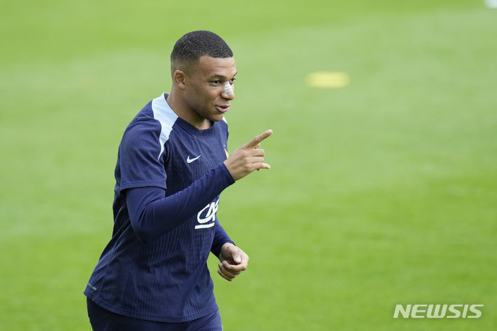 France's Kylian Mbappe runs during a training session in Paderborn, Germany, Wednesday, June 19, 2024. France will play against Netherland during their Group D soccer match at the Euro 2024 soccer tournament on June 21. (AP Photo/Hassan Ammar)