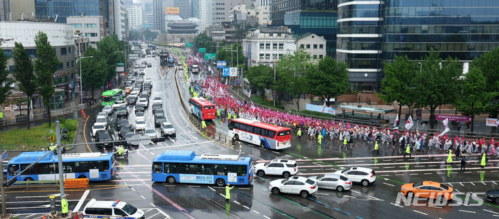 [서울=뉴시스] 전신 기자 = 22일 서울 세종대로에서 열린 전국 노동자 대회에서 전국학교비정규직노동조합 등 민주노총 조합원들이 집회를 마친 뒤 대통령실 청사 방향으로 행진하고 있다. 2024.06.22. photo1006@newsis.com