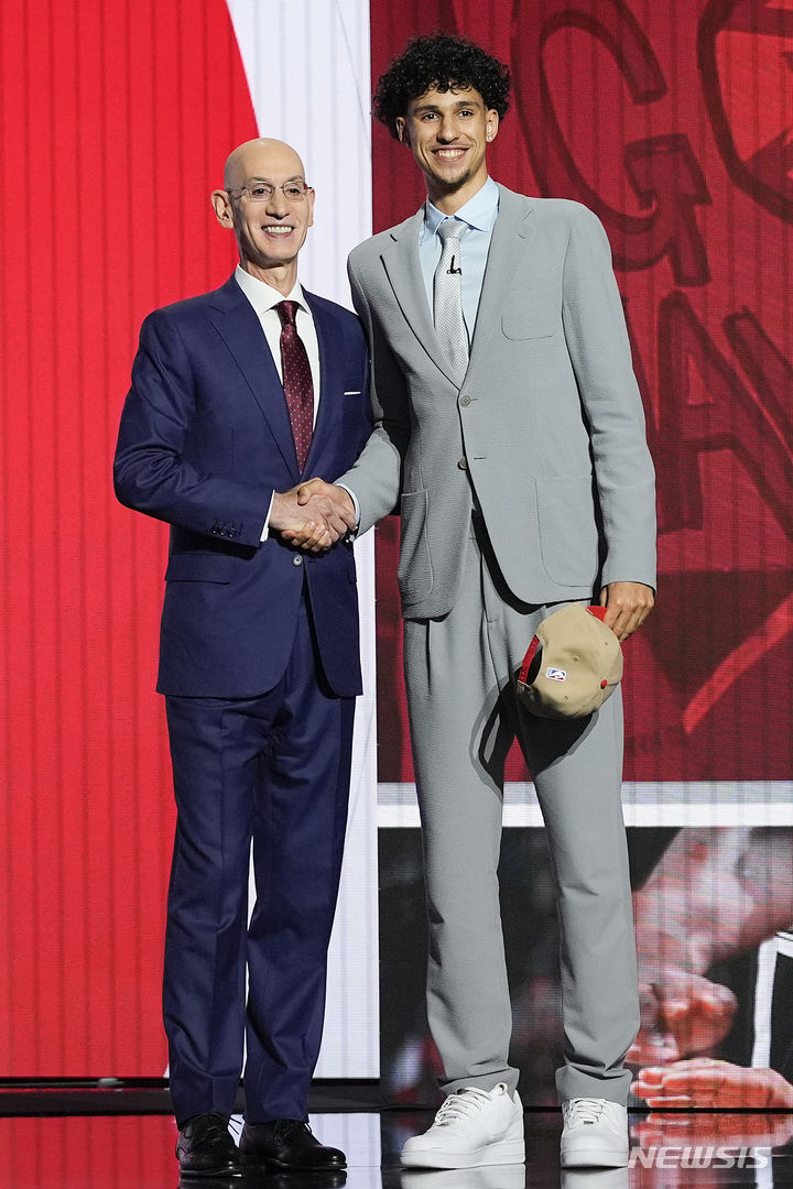 [뉴욕=AP/뉴시스] 자라키 리자셰가 27일(한국시각) 미국 뉴욕주 브루클린의 바클레이스센터에서 열린 2024 미국프로농구(NBA) 신인 드래프트에서 전체 1순위로 애틀랜타 호크스 지명을 받은 뒤 애덤 실버 NBA 커미셔너와 포즈를 취하고 있다. 2024.06.27