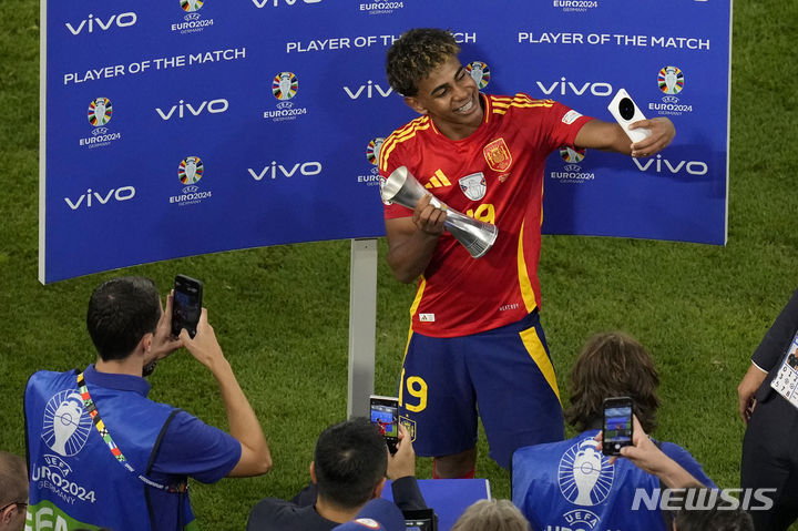 [뮌헨=AP/뉴시스] 스페인(8위)의 라민 야말이 9일(현지시각) 독일 뮌헨의 푸스발 아레나에서 열린 유로 2024 준결승전 프랑스(2위)와 경기 후 MVP에 선정돼 트로피를 들고 셀카를 찍고 있다. 야말은 전반 21분 동점 골을 넣어 유로 역대 최연소 골의 주인공이 됐으며 스페인은 2-1로 역전승을 거두고 12년 만에 결승에 올라 통산 4번째 우승을 노린다. 2024.07.10.