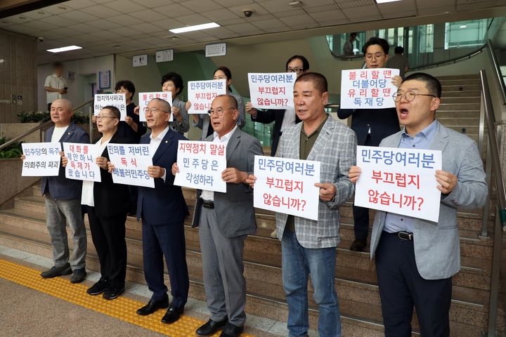 [수원=뉴시스] 10일 경기 수원시청 본관 1층 로비 계단 앞에서 수원시의회 국민의힘 의원들이 더불어민주당의 후반기 원구성 독식에 반발해 릴레이 삭발식을 갖고 민주당을 규탄하는 피켓 항의시위를 진행하고 있다. (사진=수원시의회 제공) 2024.07.10. photo@newsis.com *재판매 및 DB 금지