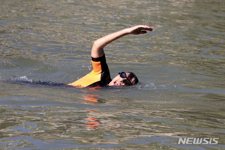 Paris Mayor Anne Hidalgo swims in the Seine river, Wednesday, July 17, 2024 in Paris. After months of anticipation, Paris Mayor Anne Hidalgo took a dip in the Seine River on Wednesday, fulfilling a promise she made months ago to show the river is clean enough to host open-swimming competitions during the 2024 Olympics — and the opening ceremony on the river nine days away.(Joel Saget, Pool via AP)