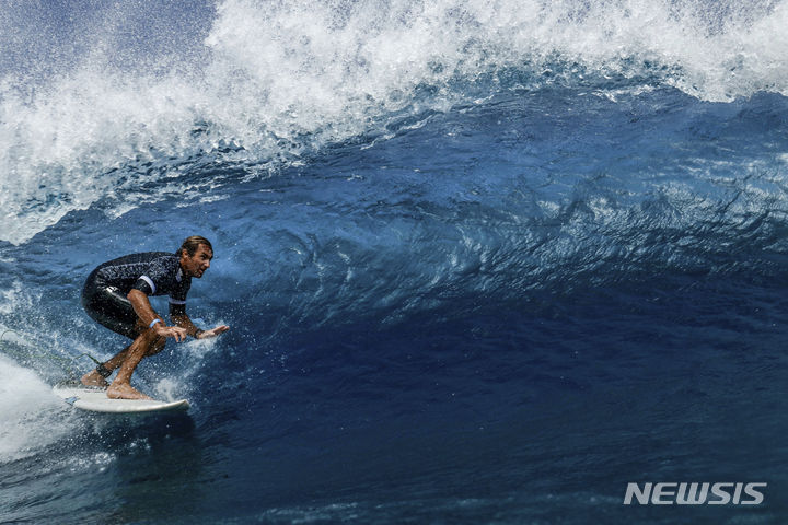 France's Joan Duru takes part in a surfing training session in Teahupo'o, on the French Polynesian Island of Tahiti, on Monday, July 22, 2024, ahead of the Paris 2024 Olympic Games. (Ben Thouard/Pool Photo via AP)