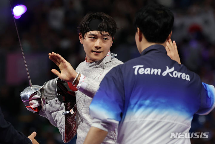 [파리=뉴시스] 김진아 기자 = 대한민국 펜싱 국가대표 오상욱이 27일(현지시간) 프랑스 파리 그랑 팔레에서 열린 파리올림픽 펜싱 남자 사브르 개인 준결승 이탈리아의 루이지 사멜레와의 경기에서 결승 진출을 확정 지은 뒤 하이파이브를 하고 있다. 2024.07.29. bluesoda@newsis.com