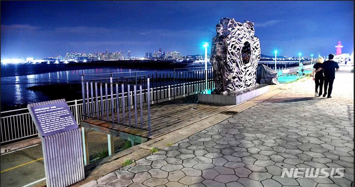 [시흥=뉴시스] 박석희기자 화려한 조명을 감상하며, 한쌍의 연인이 조각앞을 지나고 있다. (사진=시흥시 제공) 2024.7.30. photo@newsis.com *재판매 및 DB 금지