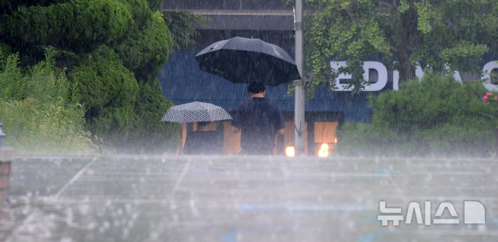 [전주=뉴시스] 김얼 기자 = 전북 전주시청 일대에서 시민들이 우산으로 비를 피하며 길을 지나고 있다. pmkeul@newsis.com
