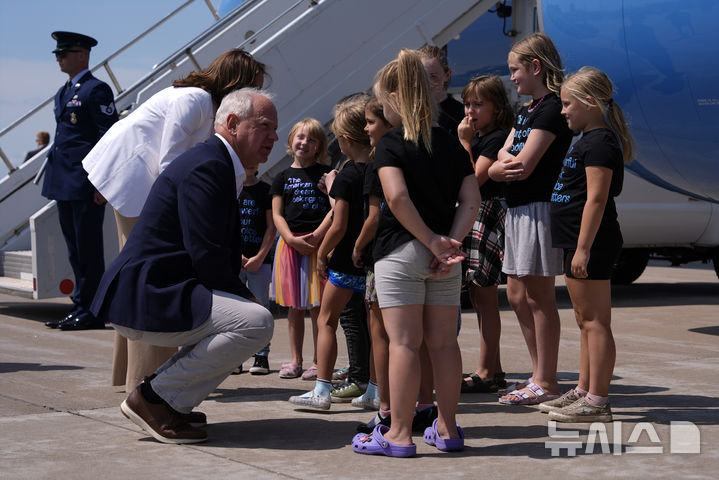 [오클레어+AP/뉴시스]팀 월즈 미 민주당 부통령 후보가 지난 7일(현지시각) 카멀라 해리스 대통령 후보와 함께 위슨콘신 주 치프와 밸리 공항에서 마중 나온 어린이들을 만나고 있다. 눈높이를 맞추기 위해 쭈그려 앉은 모습이 그의 자상한 성격을 잘 보여준다. 2024.8.9.
