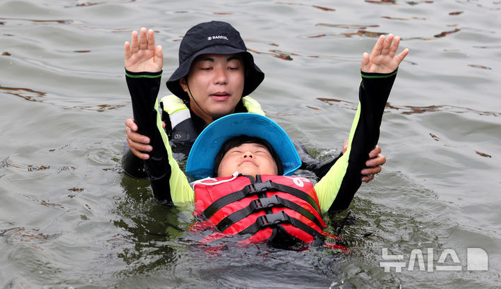 [서울=뉴시스] 추상철 기자 = 8일 오전 서울 광진구 안심생존수영교육지원센터에서 열린 '2024 여름방학 한강에서 가족과 함께 캠프'에서 참가자들이 생존수영교육을 받고 있다. 2024.08.08. scchoo@newsis.com