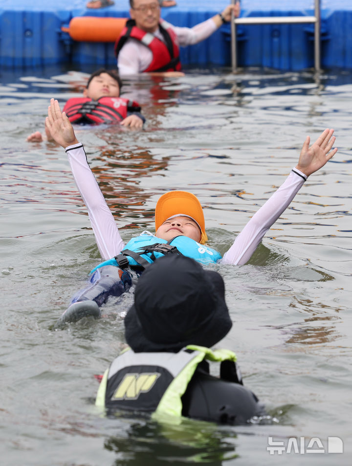 [서울=뉴시스] 추상철 기자 = 8일 오전 서울 광진구 안심생존수영교육지원센터에서 열린 '2024 여름방학 한강에서 가족과 함께 캠프'에서 참가자들이 생존수영교육을 받고 있다. 2024.08.08. scchoo@newsis.com