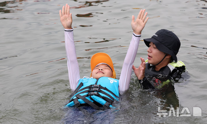 [서울=뉴시스] 추상철 기자 = 8일 오전 서울 광진구 안심생존수영교육지원센터에서 열린 '2024 여름방학 한강에서 가족과 함께 캠프'에서 참가자들이 생존수영교육을 받고 있다. 2024.08.08. scchoo@newsis.com