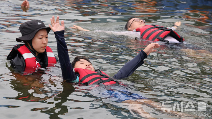 [서울=뉴시스] 추상철 기자 = 8일 오전 서울 광진구 안심생존수영교육지원센터에서 열린 '2024 여름방학 한강에서 가족과 함께 캠프'에서 참가자들이 생존수영교육을 받고 있다. 2024.08.08. scchoo@newsis.com