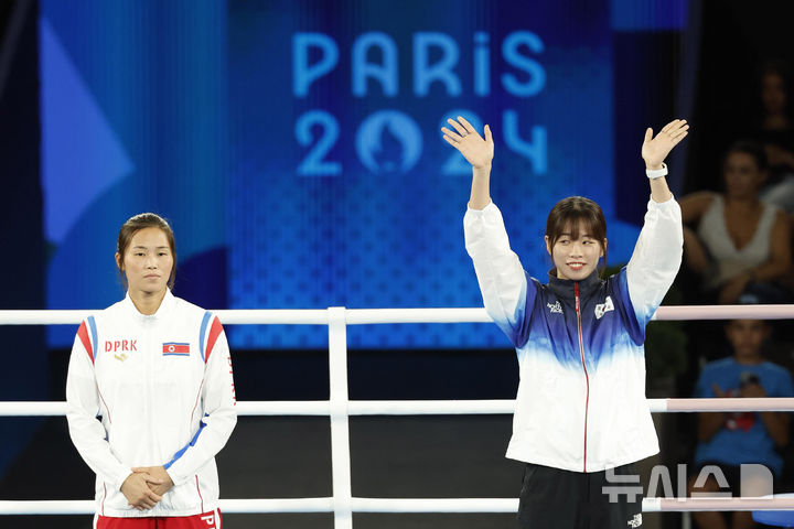 [파리=뉴시스] 최동준 기자 = 임애지가 지난해 8월8일(현지시각) 프랑스 파리 롤랑 가르스 스타디움에서 열린 2024 파리 올림픽 복싱 여자 54kg 시상식에서 동메달 수상을 위해 시상대에 오르고 있다. 왼쪽은 북한 방철미. 2024.08.09. photocdj@newsis.com
