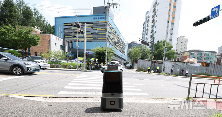 [의왕=뉴시스] 추상철 기자 = 9일 오전 경기 의왕시 부곡파출소에서 열린 '실시간 교통신호정보 활용 실외이동로봇 운행 시연회'에서 로봇이 신호를 기다리고 있다. 2024.08.09. scchoo@newsis.com