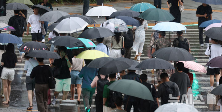 [서울=뉴시스] 추상철 기자 = 지난 21일 오전 서울 용산역 앞에서 우산을 쓴 시민들이 횡단보도를 건너고 있다. 2024.08.21. scchoo@newsis.com