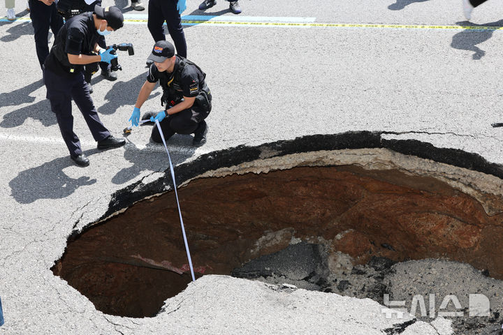 [서울=뉴시스] 황준선 기자 = 29일 서울 서대문구 성산로에 땅꺼짐 사고가 발생해 과학수사대원들이 사고 현장을 조사하고 있다. 2024.08.29 hwang@newsis.com