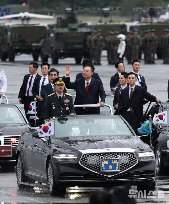 [성남=뉴시스] 조수정 기자 = 윤석열 대통령이 1일 성남 서울공항에서 열린 건군 제76주년 국군의날 기념식에서 열병차량에 탑승해 사열하며 손을 들어 보이고 있다. 2024.10.01. chocrystal@newsis.com